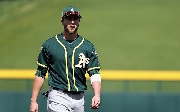 Dustin Fowler #11 of the Oakland Athletics warms up before the spring training game against the Chi...