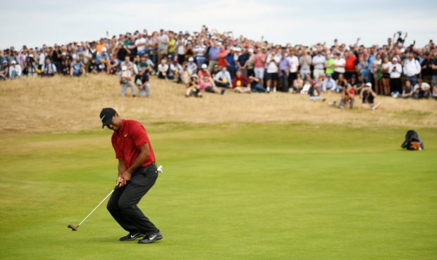 CARNOUSTIE, SCOTLAND - JULY 22: Tiger Woods of the United States reacts to a putt for birdie on the...