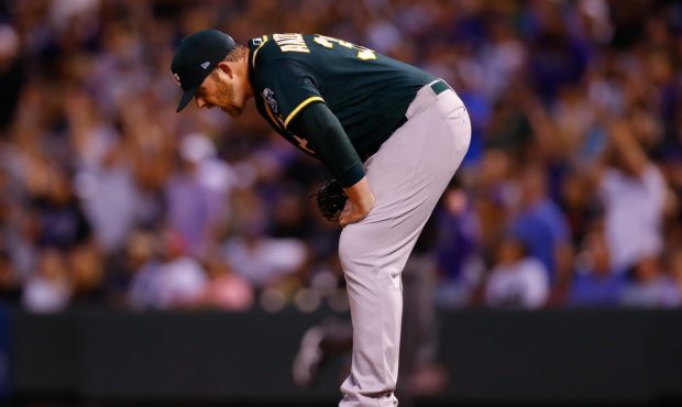 DENVER, CO - JULY 28:  Starting pitcher Brett Anderson #30 of the Oakland Athletics reacts after gi...
