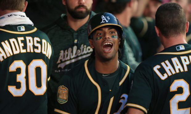 ANAHEIM, CA - AUGUST 10: Khris Davis #2 of the Oakland Athletics is congratulated in the dugout aft...
