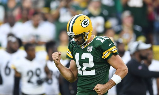Aaron Rodgers #12 of the Green Bay Packers celebrates a touchdown pass during the first quarter of ...