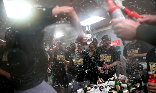 SEATTLE, WA - SEPTEMBER 24:  Oakland Athletics players celebrate clinching a spot in the playoffs a...