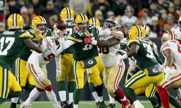 GREEN BAY, WI - OCTOBER 15:  Aaron Rodgers #12 of the Green Bay Packers throws a pass under pressur...