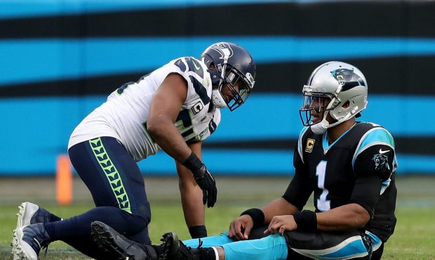 CHARLOTTE, NC - NOVEMBER 25: Bobby Wagner #54 of the Seattle Seahawks hits Cam Newton #1 of the Car...