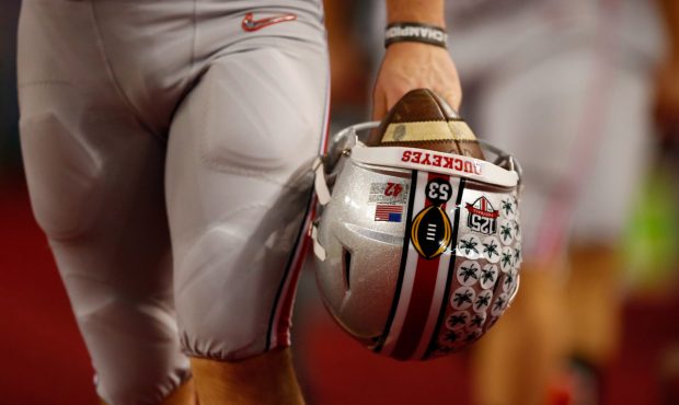 ARLINGTON, TX - JANUARY 12: An Ohio State Buckeyes player hold his helmet on the sideline during th...