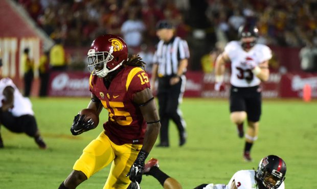 LOS ANGELES, CA - SEPTEMBER 05: Isaac Whitney #15 of the USC Trojanst runs by Rocky Hayes #3 of the...