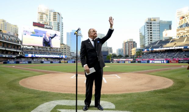 SAN DIEGO, CALIFORNIA - SEPTEMBER 29:  San Diego Padres announcer Dick Enberg waves to the crowd du...