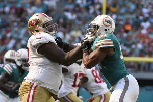 MIAMI GARDENS, FL - NOVEMBER 27: Trent Brown #77 of the San Francisco 49ers blocks Cameron Wake #91 of the Miami Dolphins during the 1st quarter of the game at Hard Rock Stadium on November 27, 2016 in Miami Gardens, Florida.