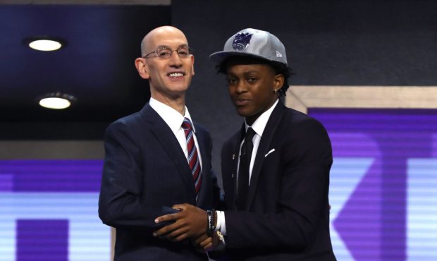 NEW YORK, NY - JUNE 22:  De?Aaron Fox walks on stage with NBA commissioner Adam Silver after being ...