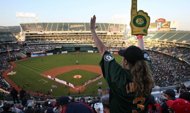 An Oakland A's fan cheers before the start of the Opening Day game of the Oakland Athletics and The...