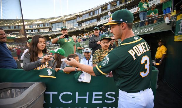 OAKLAND, CA - AUGUST 12: Boog Powell #3 of the Oakland Athletics passes out Topps trading cards to ...