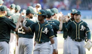 ARLINGTON, TX - OCTOBER 1: Khris Davis #2 of the Oakland Athletics, second from left, celebrates a 5-2 win with his teammates after a baseball game against the Texas Rangers at Globe Life Park October 1, 2017 in Arlington, Texas. (Photo by Brandon Wade/Getty Images)