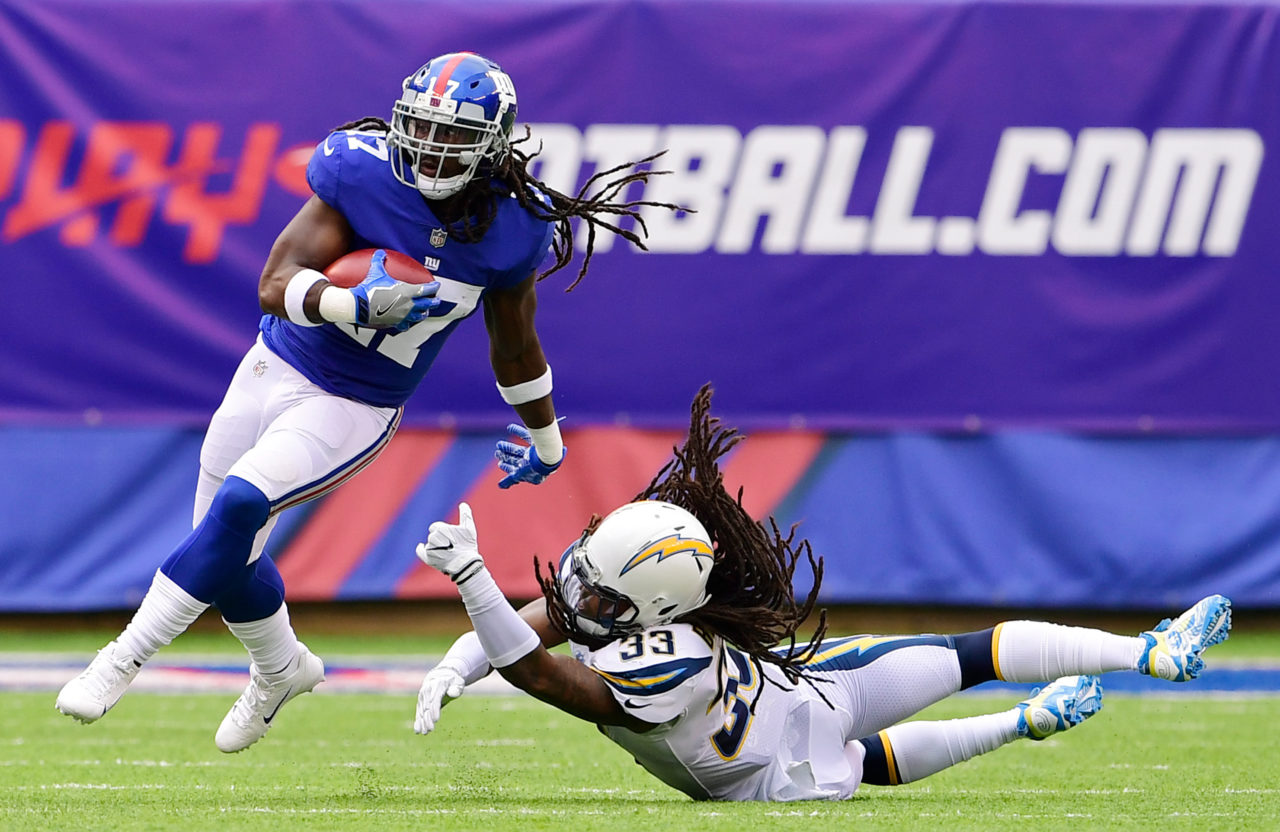 EAST RUTHERFORD, NJ - OCTOBER 08: Dwayne Harris #17 of the New York Giants returns the punt past Tre Boston #33 of the Los Angeles Chargers in the first quarter during an NFL game at MetLife Stadium on October 8, 2017 in East Rutherford, New Jersey. 