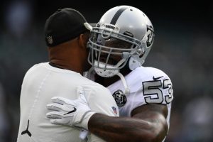 OAKLAND, CA - OCTOBER 19:  Defensive Coordinator Ken Norton Jr. hugs NaVorro Bowman #53 of the Oakland Raiders during warms up prior to their game against the Kansas City Chiefs at Oakland-Alameda County Coliseum on October 19, 2017 in Oakland, California.  