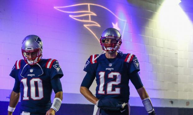 FOXBORO, MA - OCTOBER 22:  Tom Brady #12 and Jimmy Garoppolo #10 of the New England Patriots walk t...