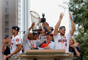 HOUSTON, TX - NOVEMBER 03: Houston Mayor Sylvestor Turner lifts up the Championship Trophy as Carlos Correa #1, Astros owner Jim Crane and George Springer #4 during the Houston Astros Victory Parade on November 3, 2017 in Houston, Texas. The Astros defeated the Los Angeles Dodgers 5-1 in Game 7 to win the 2017 World Series.