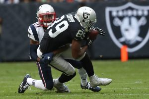 MEXICO CITY, MEXICO - NOVEMBER 19: Amari Cooper #89 of the Oakland Raiders is tackled by Malcolm Butler #21 of the New England Patriots during the first half at Estadio Azteca on November 19, 2017 in Mexico City, Mexico.