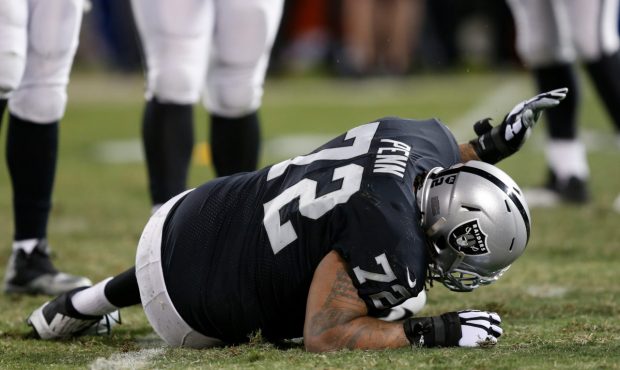 OAKLAND, CA - DECEMBER 17: Donald Penn #72 of the Oakland Raiders lays on the field after being inj...