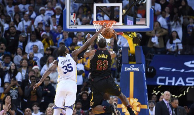 OAKLAND, CA - DECEMBER 25:  Kevin Durant #35 of the Golden State Warriors blocks the shot of LeBron...