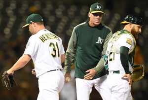 OAKLAND, CA - APRIL 03: Manager Bob Melvin #6 of the Oakland Athletics takes the ball from relief pitcher Liam Hendriks #31 taking him out of the game against the Texas Rangers in the top of the seventh inning at Oakland Alameda Coliseum on April 3, 2018 in Oakland, California. (Photo by Thearon W. Henderson/Getty Images)