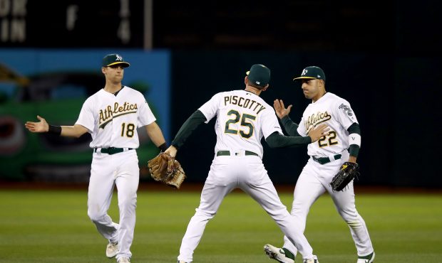 OAKLAND, CALIFORNIA - APRIL 17:   Chad Pinder #18, Stephen Piscotty #25 and Ramon Laureano #22 of t...