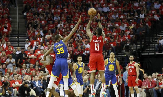 HOUSTON, TX - MAY 06:  James Harden #13 of the Houston Rockets takes a three point shot defended by...