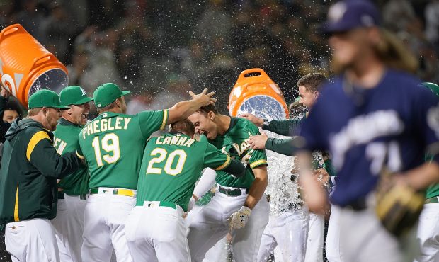 OAKLAND, CA - JULY 30:  Matt Olson #28 of the Oakland Athletics and his teammates celebrate after O...