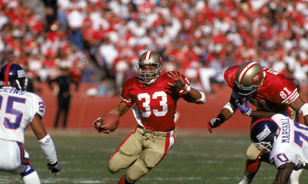 Running back Roger Craig #33 of the San Francisco 49ers looks for room to run during the 1990 NFC C...