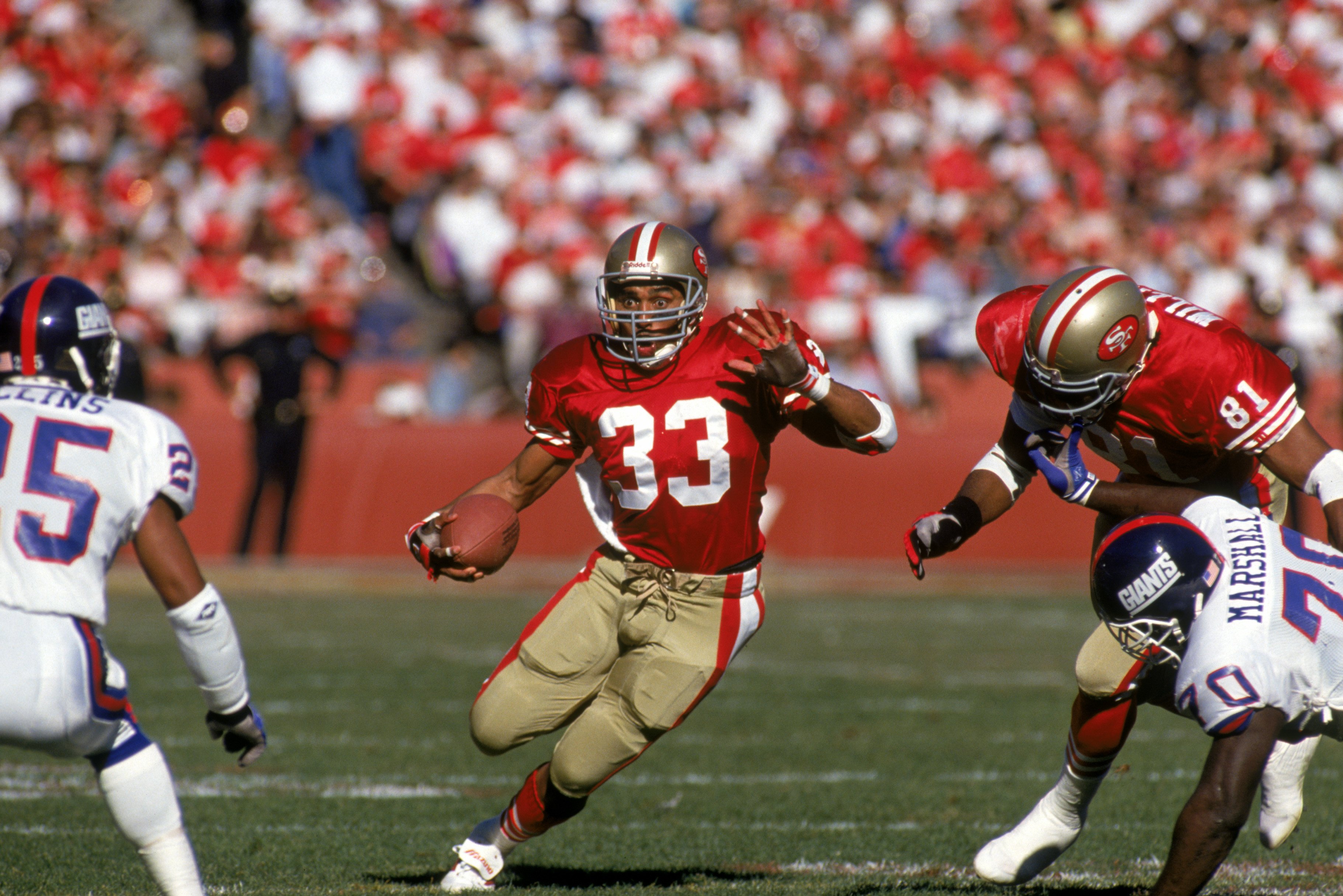 Running back Roger Craig #33 of the San Francisco 49ers looks for room to run during the 1990 NFC Championship game against the New York Giants at Candlestick Park on January 20, 1991 in San Francisco, California. The Giants won 15-13.