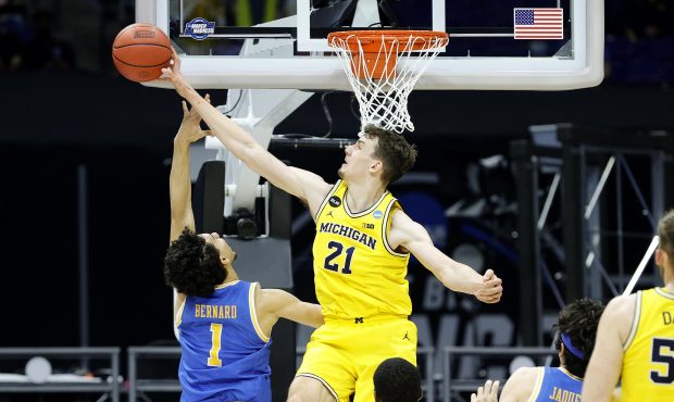 INDIANAPOLIS, INDIANA - MARCH 30: Franz Wagner #21 of the Michigan Wolverines blocks a shot by Jule...