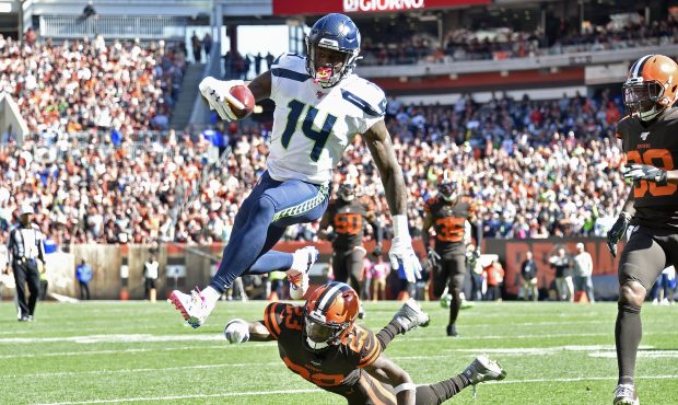CLEVELAND, OHIO - OCTOBER 13: D.K. Metcalf #14 of the Seattle Seahawks leaps over Damarious Randall...