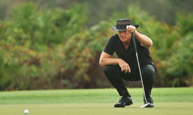 ORLANDO, FLORIDA - DECEMBER 20: Greg Norman of Australia lines up a putt on the third green during ...