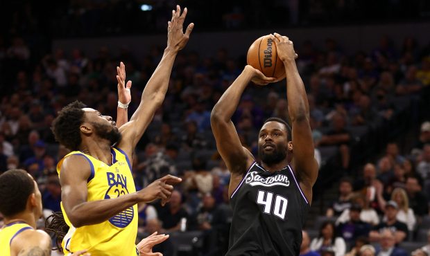 Harrison Barnes #40 of the Sacramento Kings shoots over Andrew Wiggins #22 of the Golden State Warr...