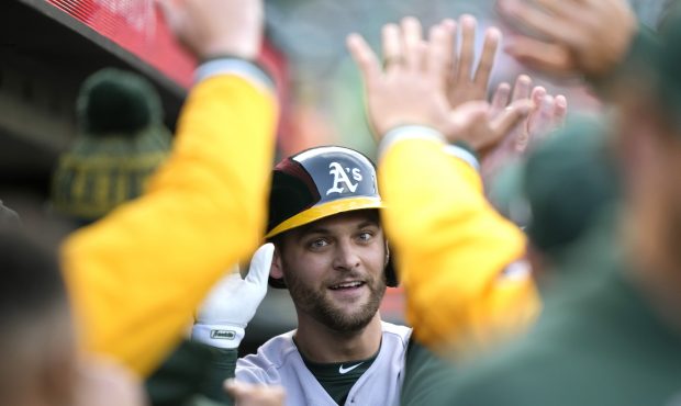 SAN FRANCISCO, CALIFORNIA - APRIL 27: Chad Pinder #10 of the Oakland Athletics is congratulated by ...