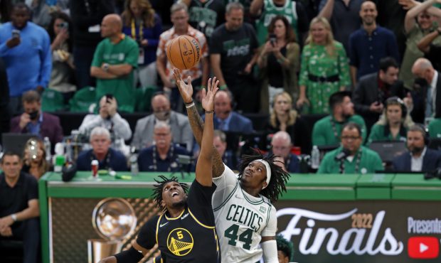 Boston - June 8: The Celtics Robert Williams (right) jumps center with the Warriors Kevon Looney (l...