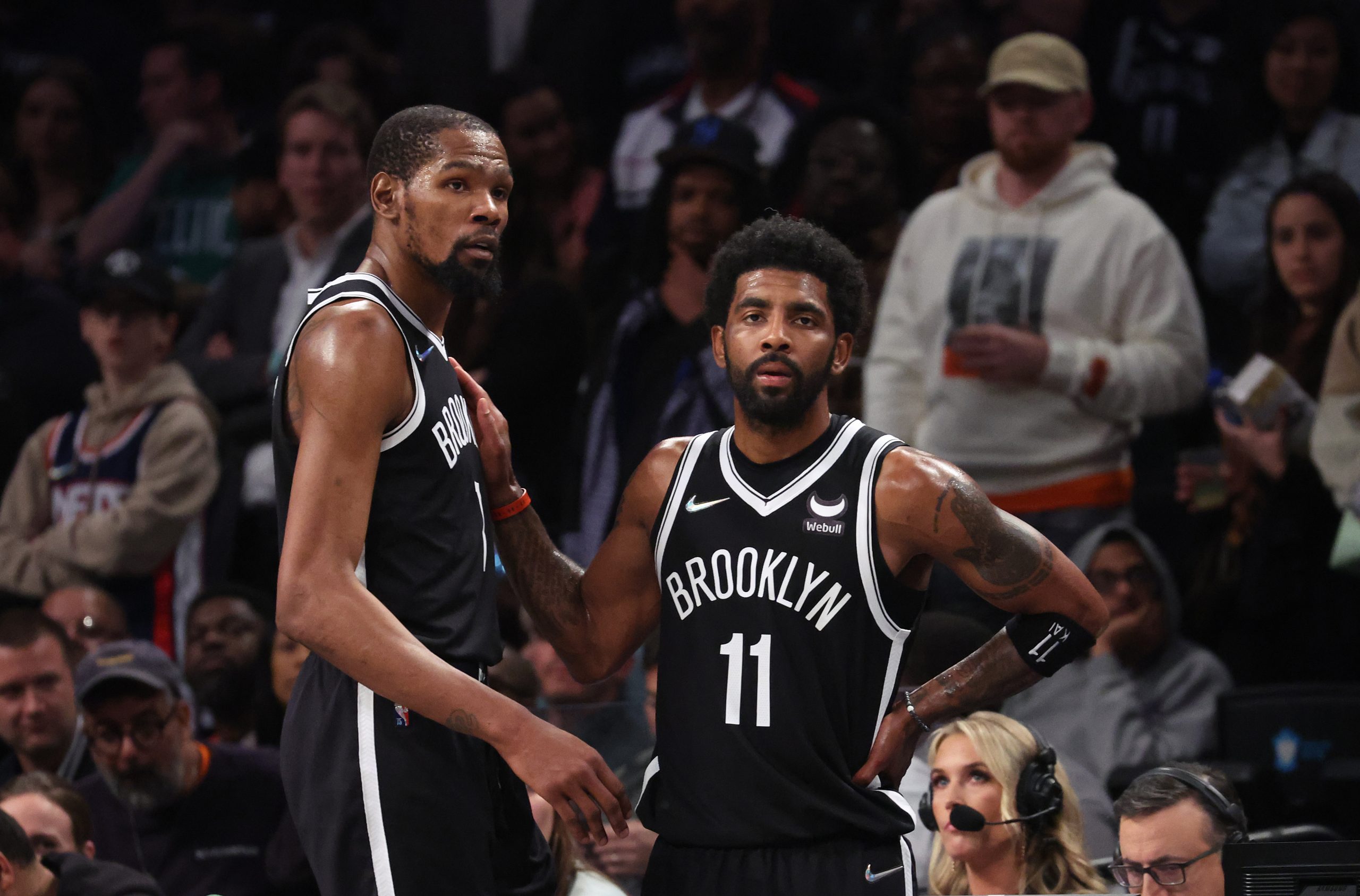 NEW YORK, NEW YORK - APRIL 23: Kevin Durant #7 and Kyrie Irving #11 of the Brooklyn Nets look on in...