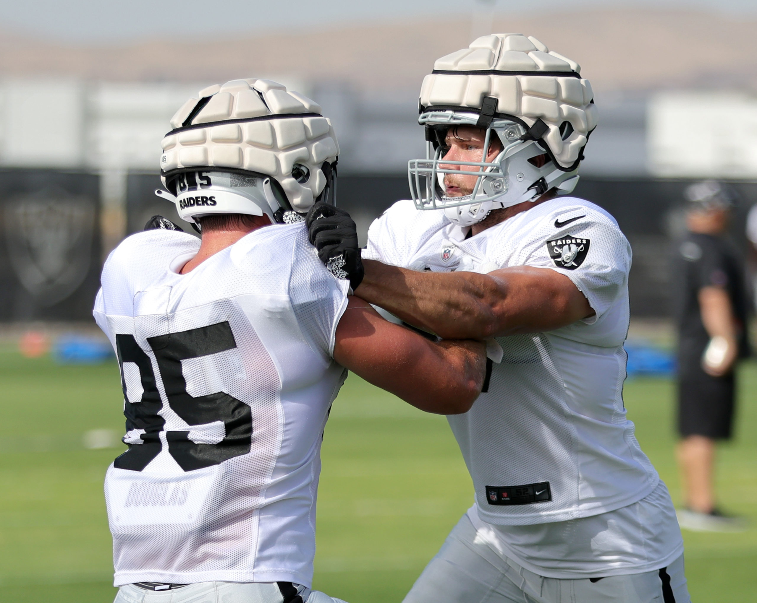 Tight ends Cole Fotheringham and Foster Moreau run through a blocking drill during the team's first...