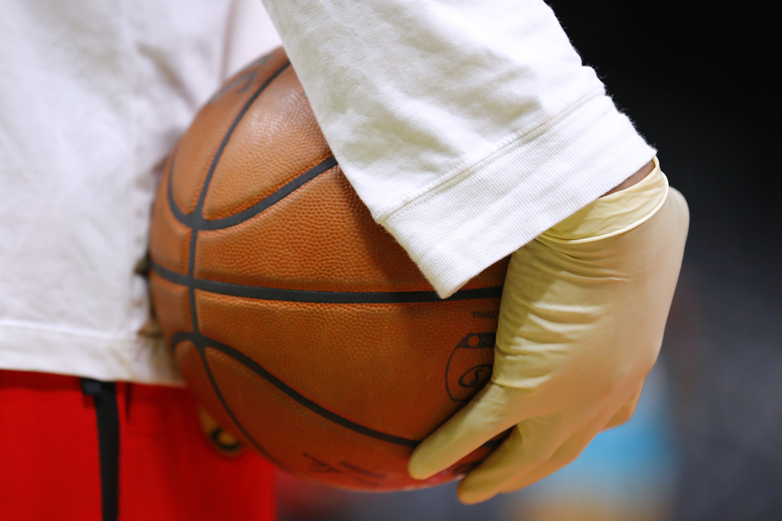ATLANTA, GA - MARCH 09: Ballboys wear gloves while handling warmup basketballs as a precautionary m...