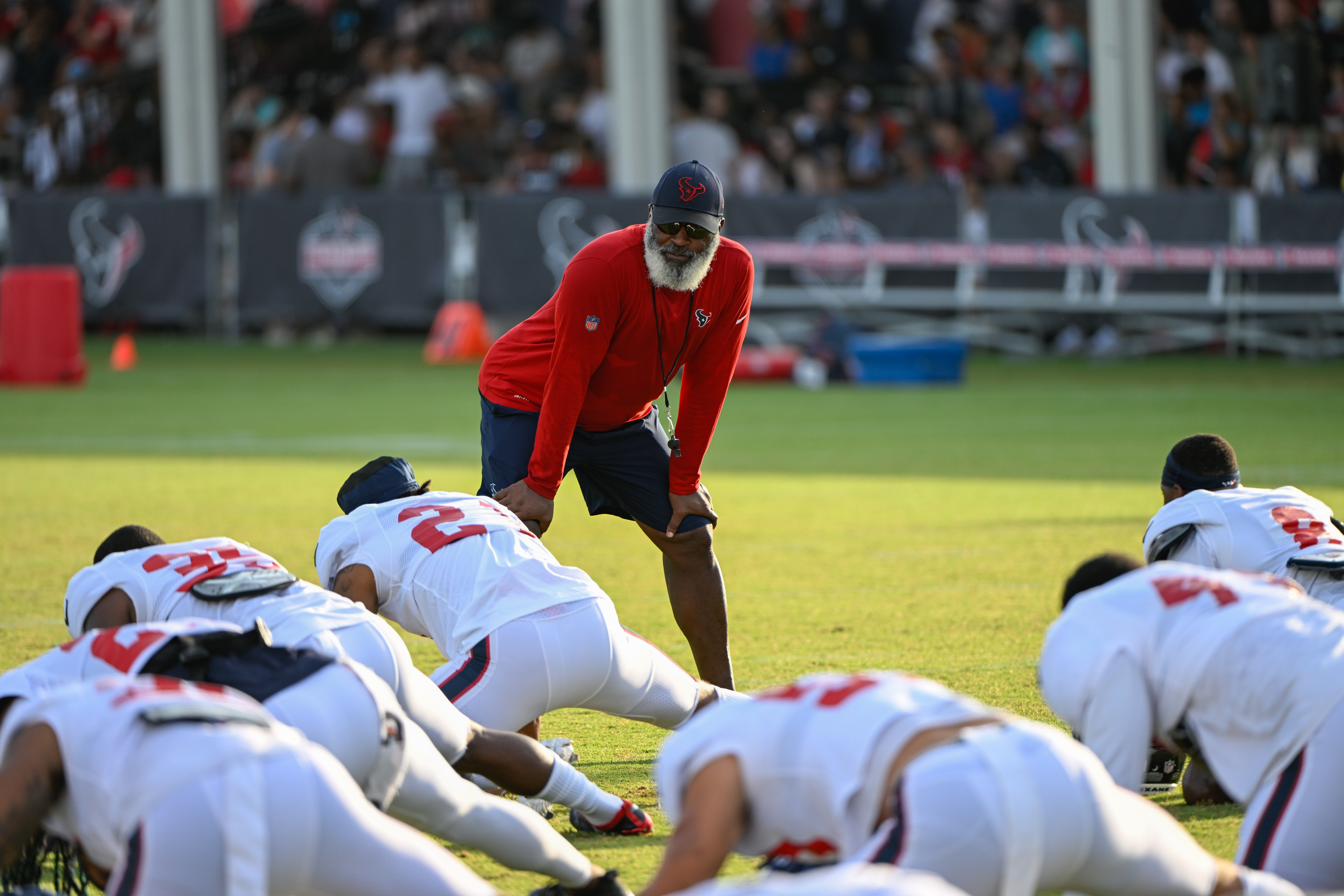 Houston Texans head coach Lovie Smith chats wtih his team as they stretch out during the Houston Te...