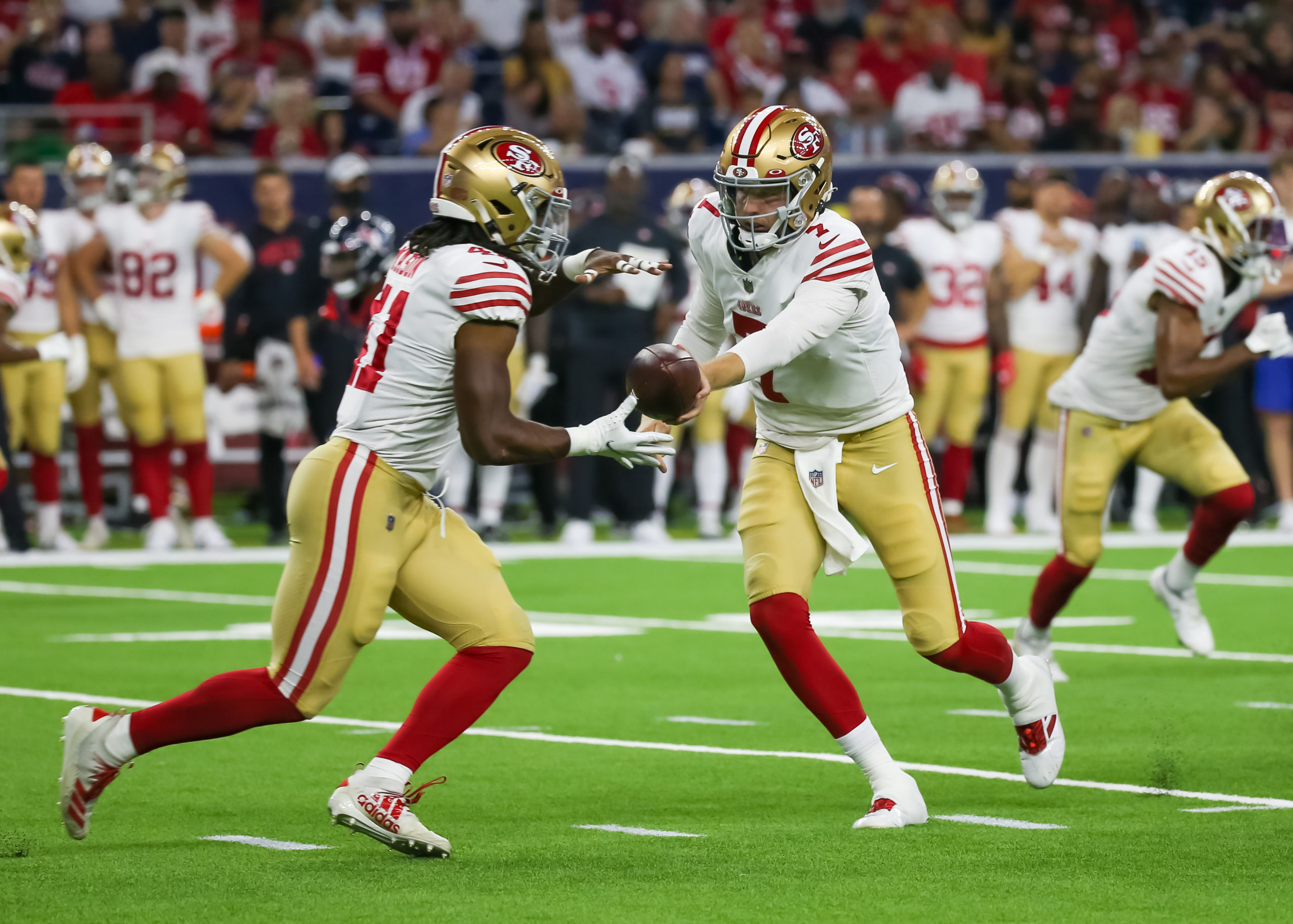 San Francisco 49ers quarterback Nate Sudfeld (7) hands the ball to San Francisco 49ers running back...