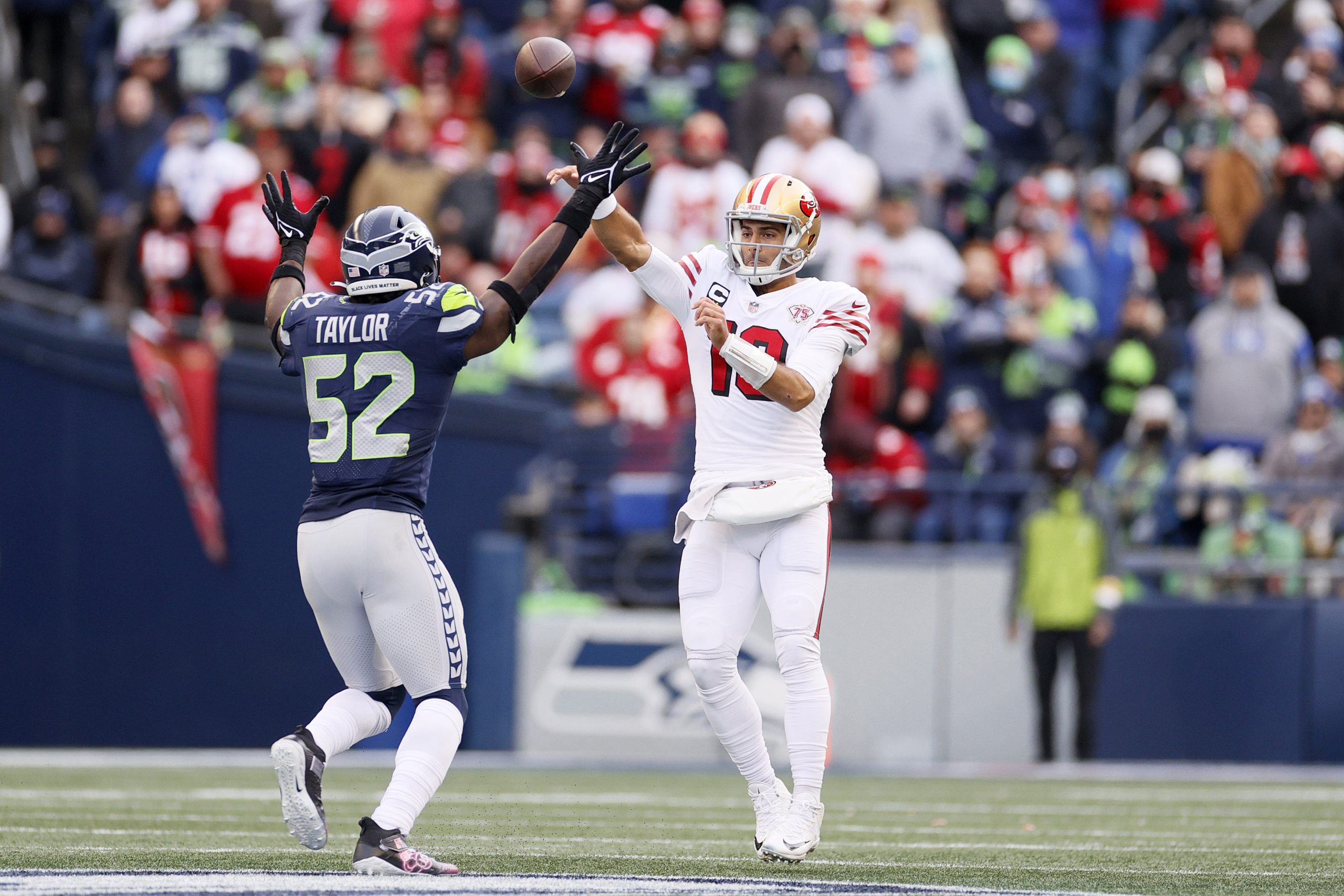 Darrell Taylor #52 of the Seattle Seahawks pressures Jimmy Garoppolo #10 of the San Francisco 49ers...