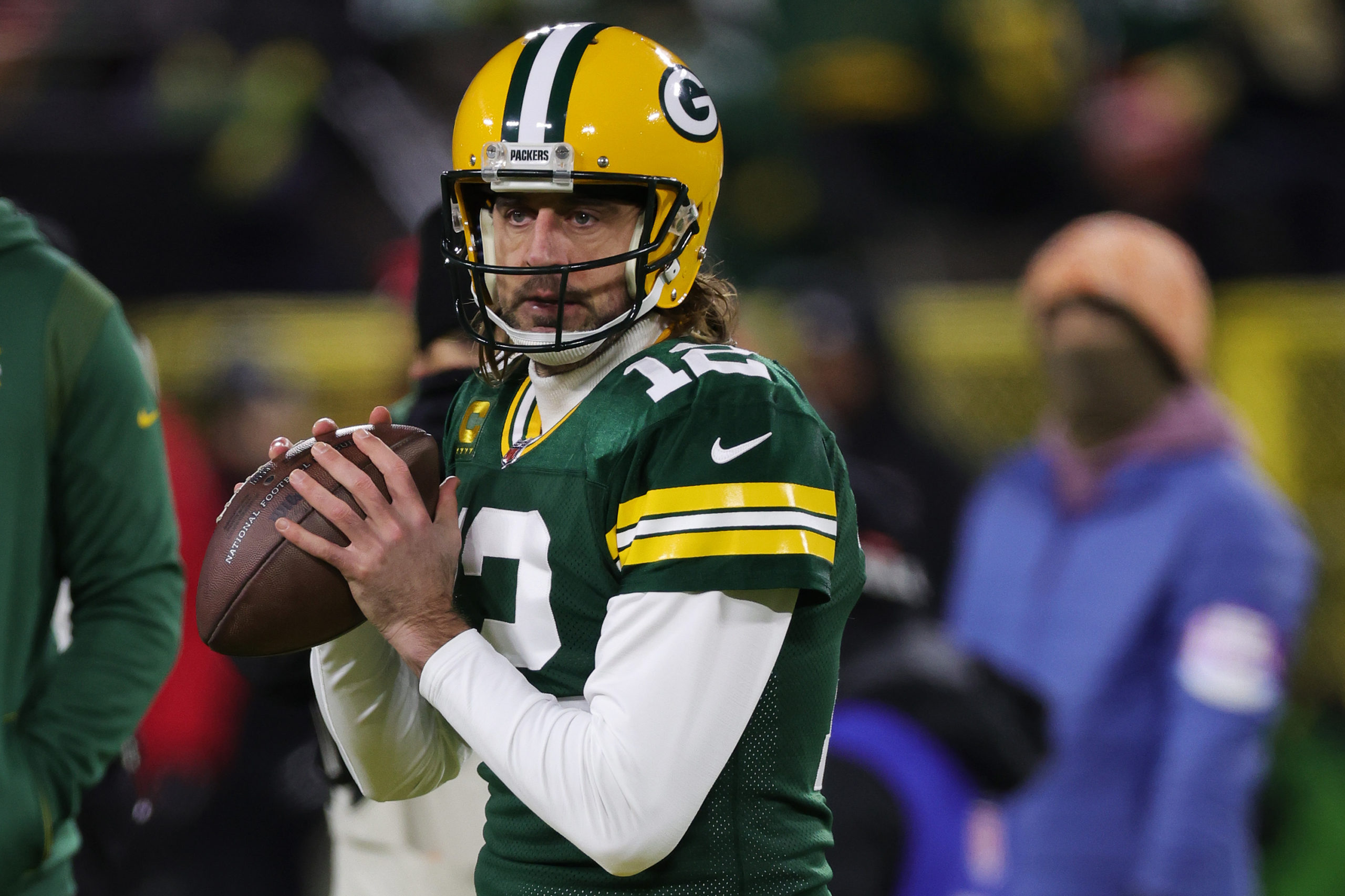 Aaron Rodgers #12 of the Green Bay Packers warms in NFC Divisional Playoff game at Lambeau Field on...