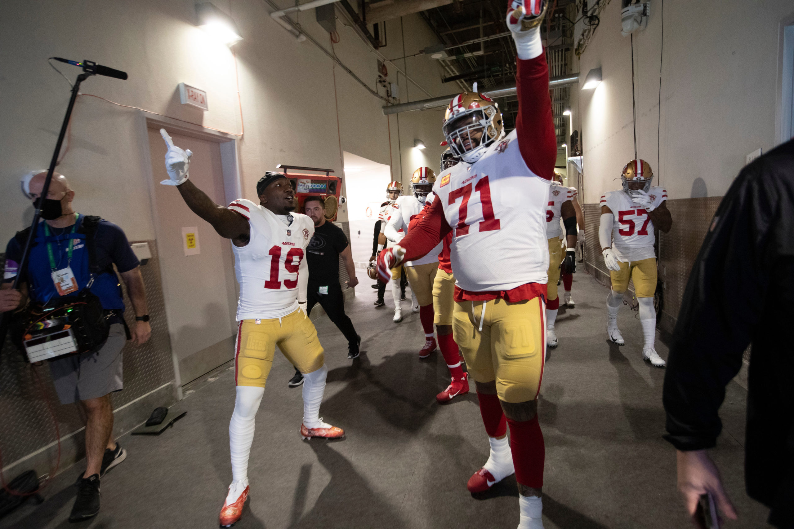 Deebo Samuel #19 and Trent Williams #71 of the San Francisco 49ershead to the field before the game...