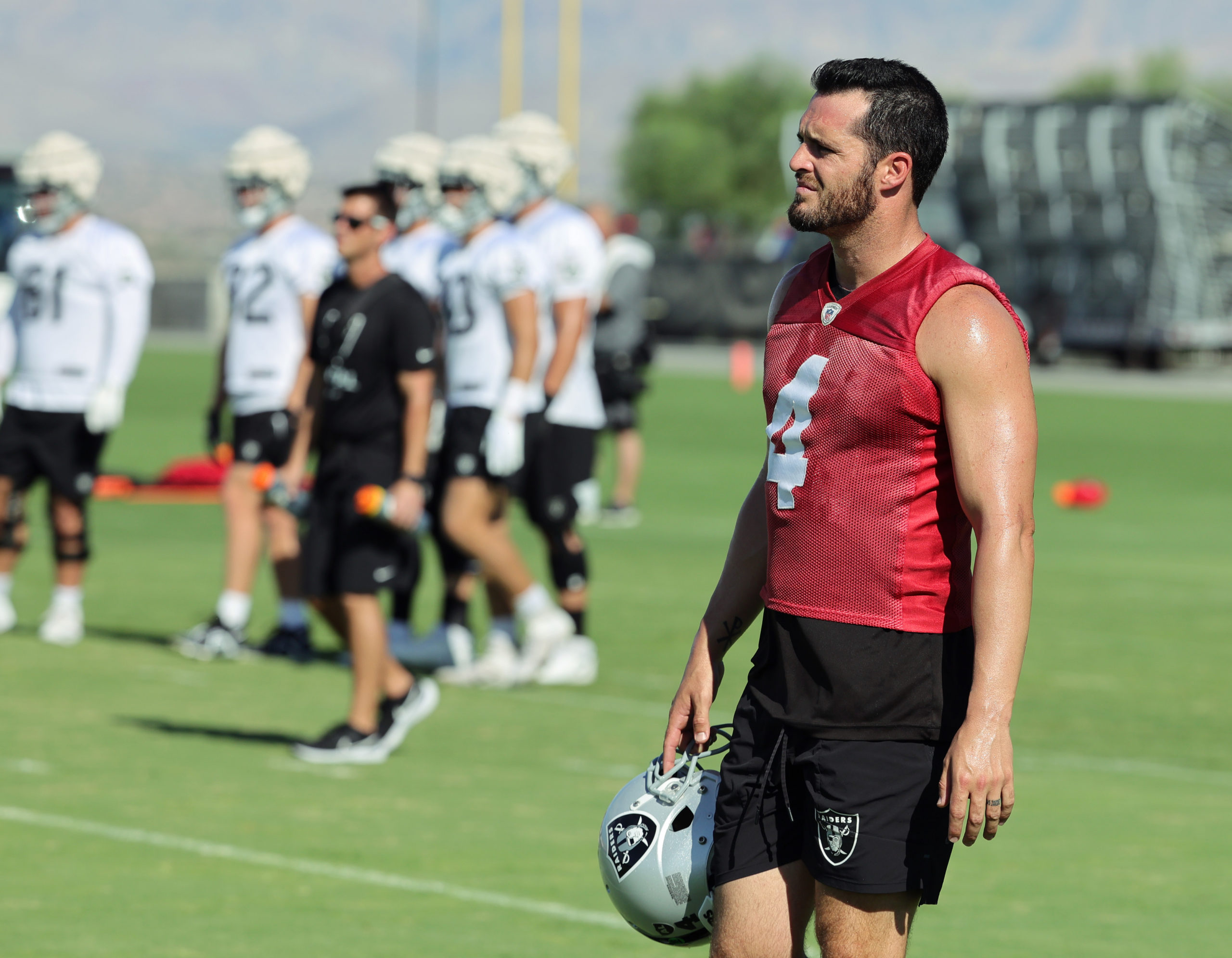 Derek Carr walks on the field during Las Vegas Raiders training camp practice....