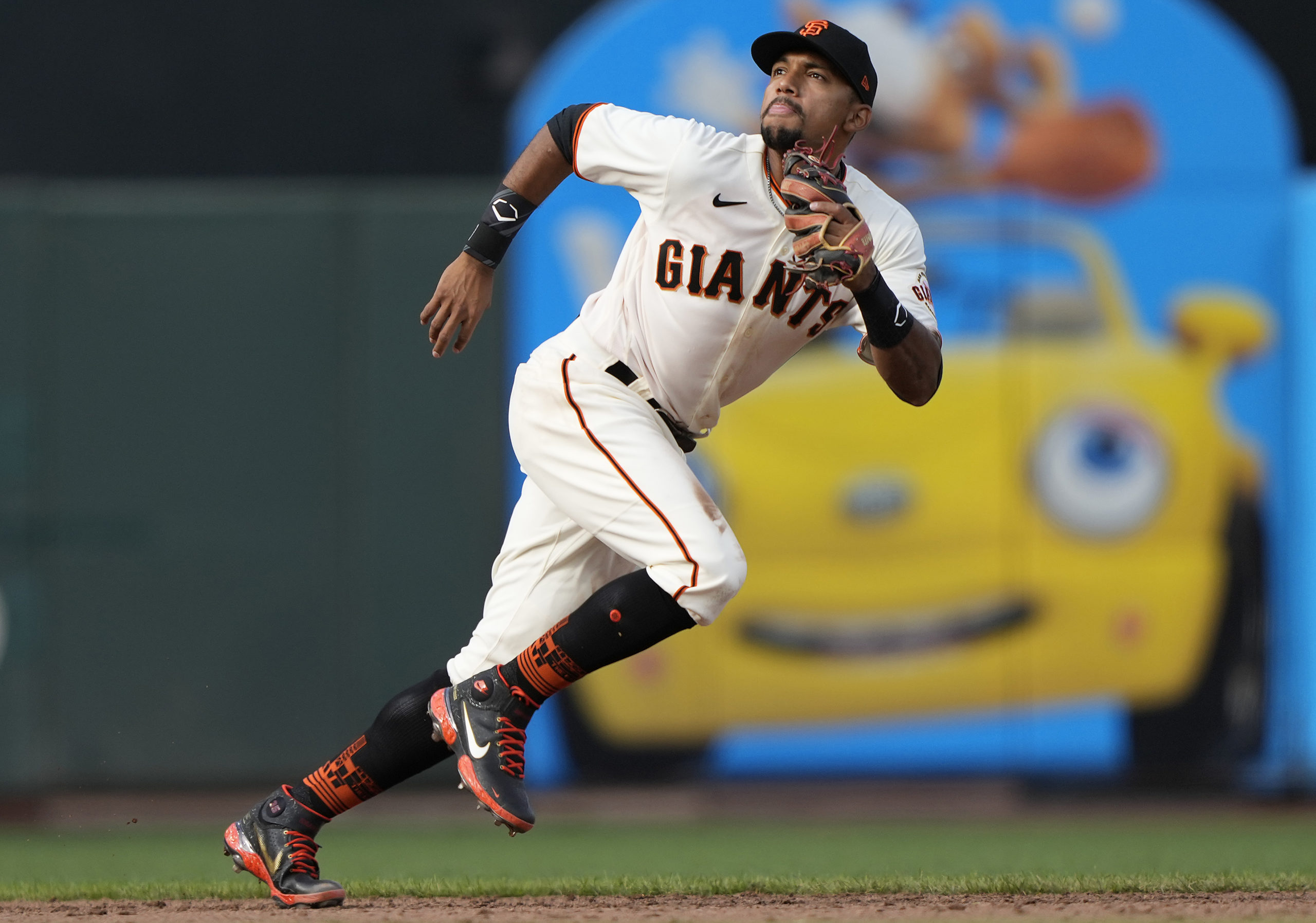 Dixon Machado of the San Francisco Giants chases down a fly ball....