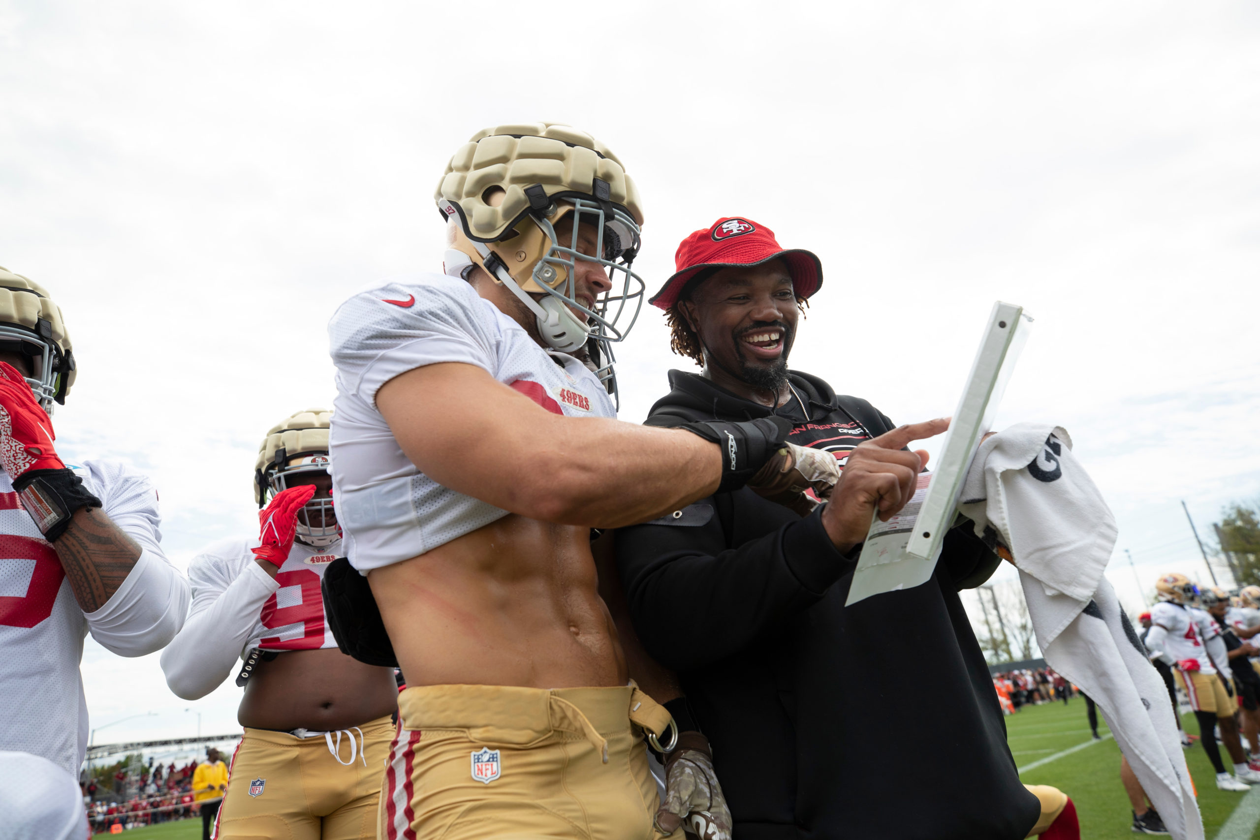 Nick Bosa #97 and Assistant Defensive Line Coach Darryl Tapp of the San Francisco 49ers during trai...