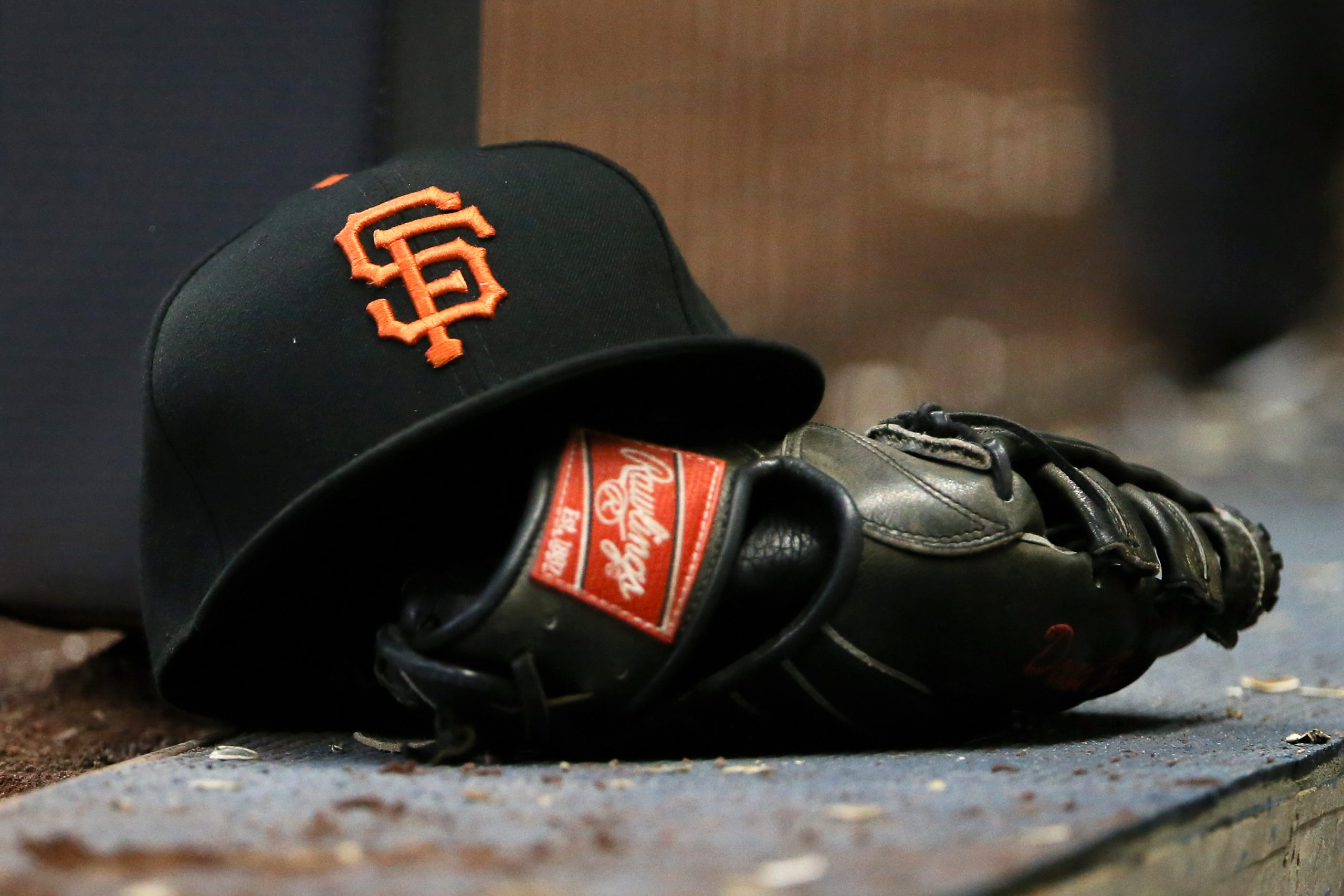 MILWAUKEE, WI - JUNE 05: A detail view of a San Francisco Giants hat and a Rawlings glove during th...