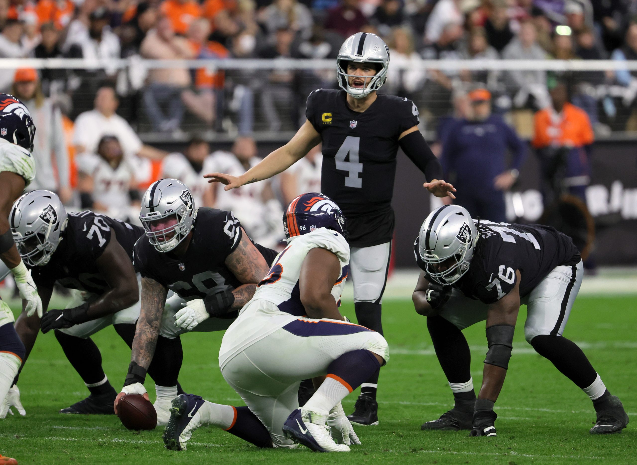 Quarterback Derek Carr #4 of the Las Vegas Raiders calls a play at the line of scrimmage during a g...