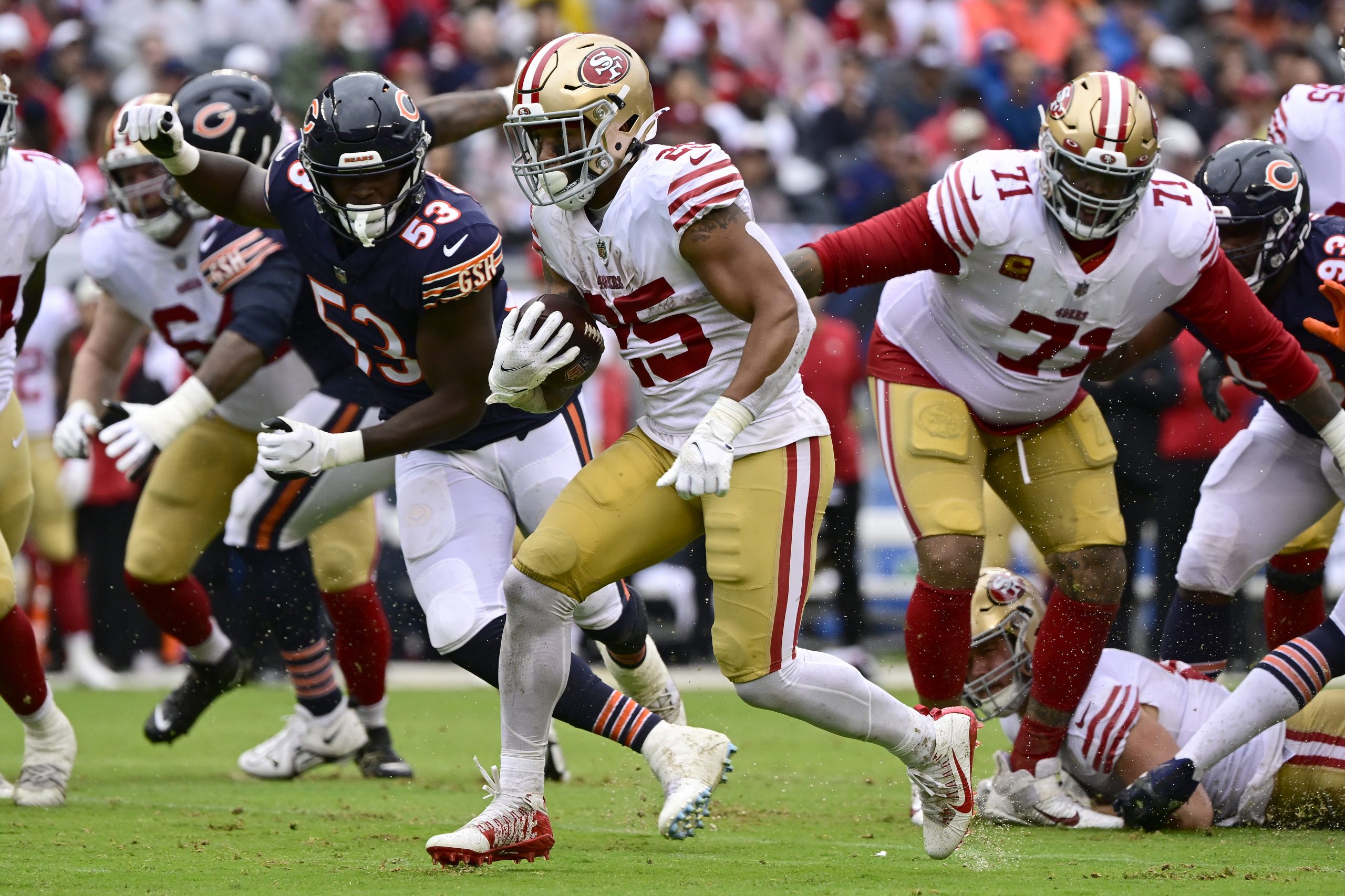 Elijah Mitchell #25 of the San Francisco 49ers rushes for a first down in the second quarter agains...