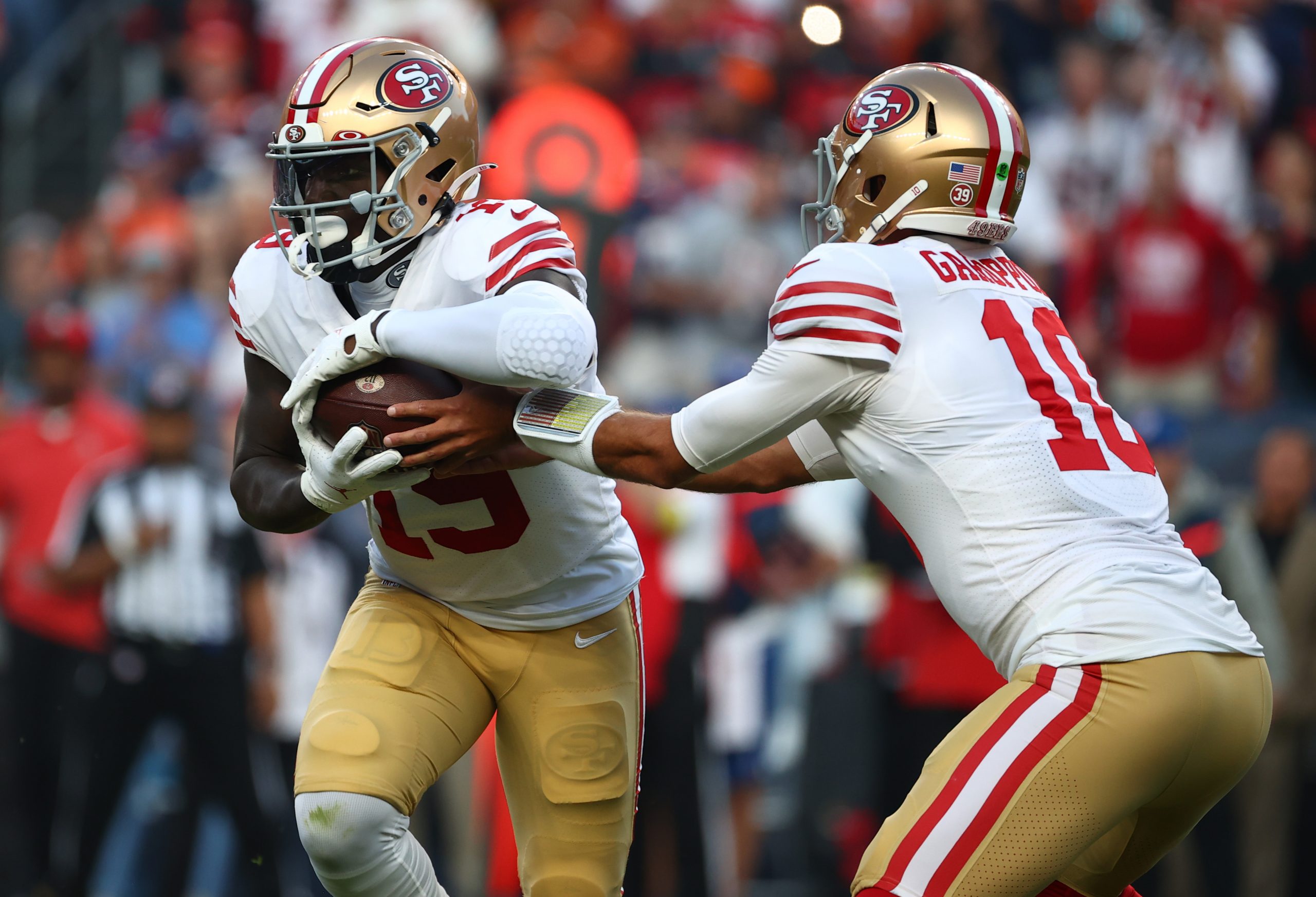 Jimmy Garoppolo #10 of the San Francisco 49ers hands off to Deebo Samuel #19 during the first half ...